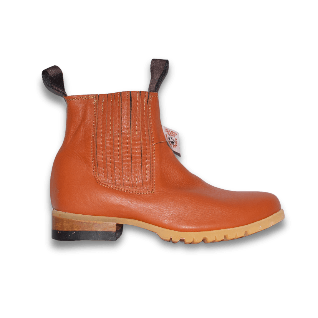 Botín Jaripeo en piel naranja con suela de tractor, vista lateral